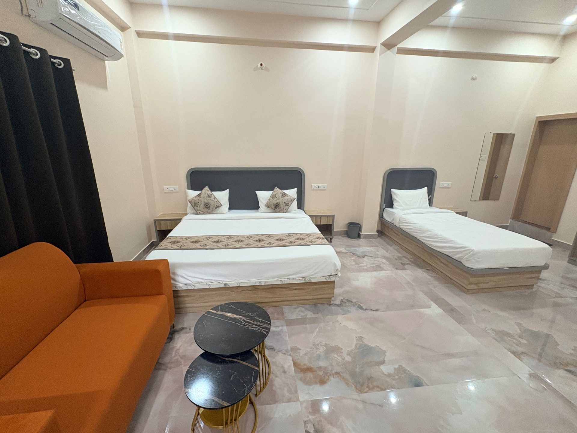 Classic Room — rust sofa, nesting tables and beds