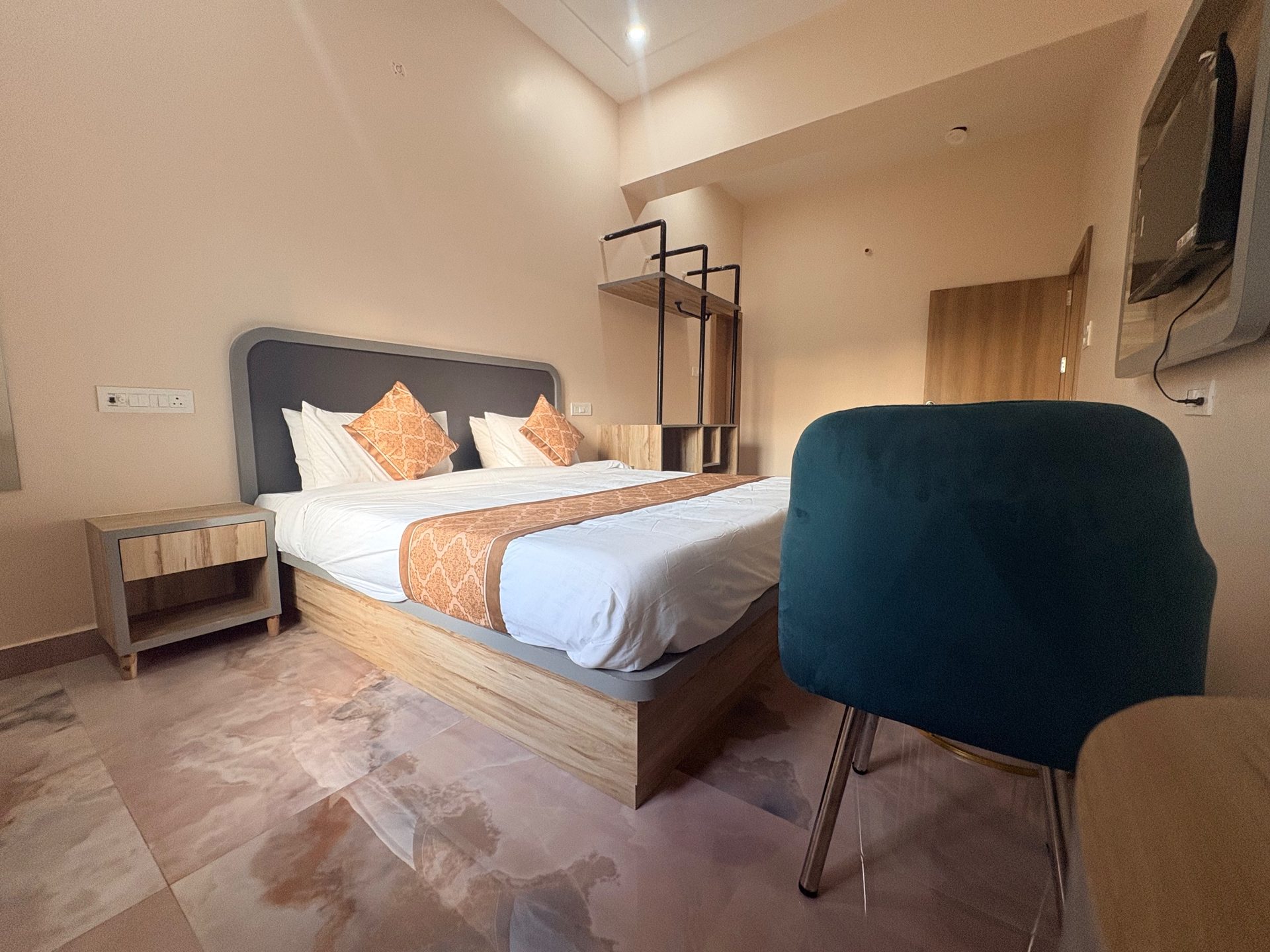 Deluxe Room bed with patterned runner and cushions