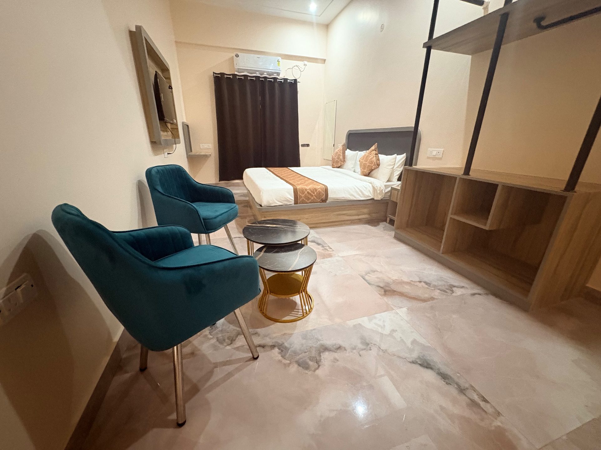 Deluxe Room seating corner with open wardrobe