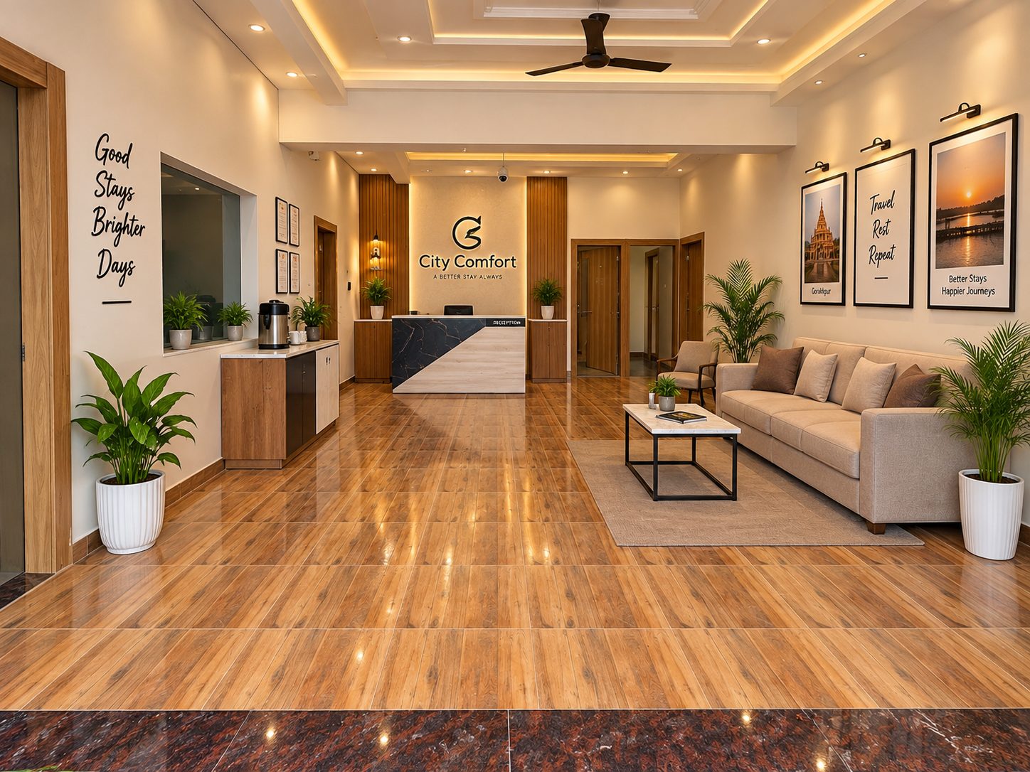The lobby at City Comfort Hotel — wood floors, a lounge sofa and framed art under cove lighting
